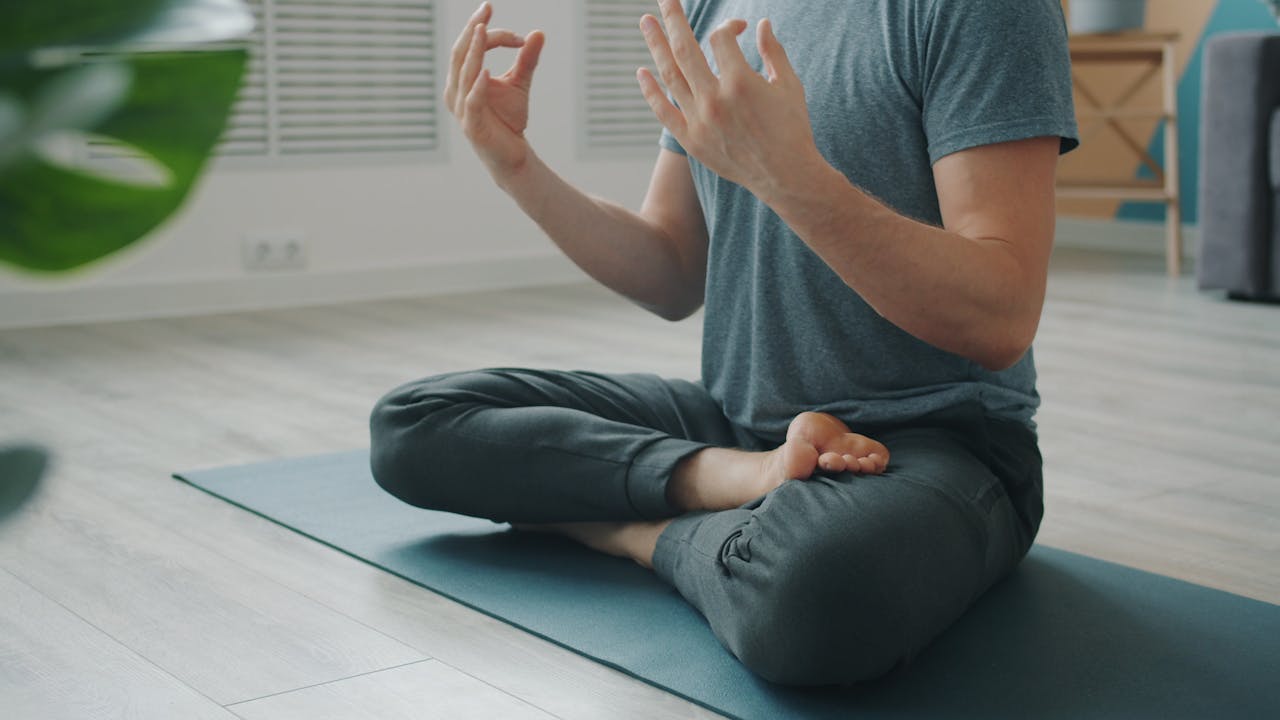 why-choose-us Adult man sitting in yoga pose during meditation at home